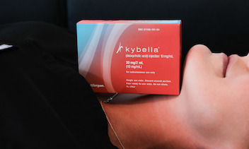 Kybella product resting on a woman's chin