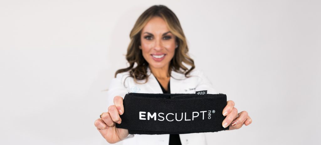 Holding up the emsculpt neo device